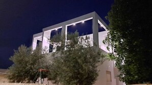 A modern building with a geometric facade and illuminated windows at night. - Mount Tabor Home by Sea N' Rent (Emek Izrael)