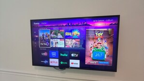 A flat-screen TV mounted on a wall displaying a streaming service interface with various content options. - Acre Inn- private countryside home south of Nashville, 15 min to Spring Hill (Spring Hill)