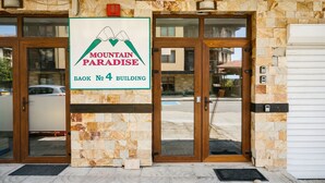 A building entrance with a sign reading "Mountain Paradise Book No 4 Building".