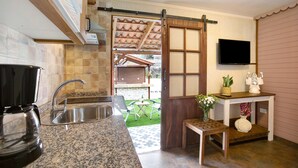 A kitchen with a coffee maker, sink, and a sliding door leading to a patio. - Vacation Home 'Los Diablitos 5' with Mountain View, Shared Terrace and Wi-Fi (Santa Cruz de Tenerife)