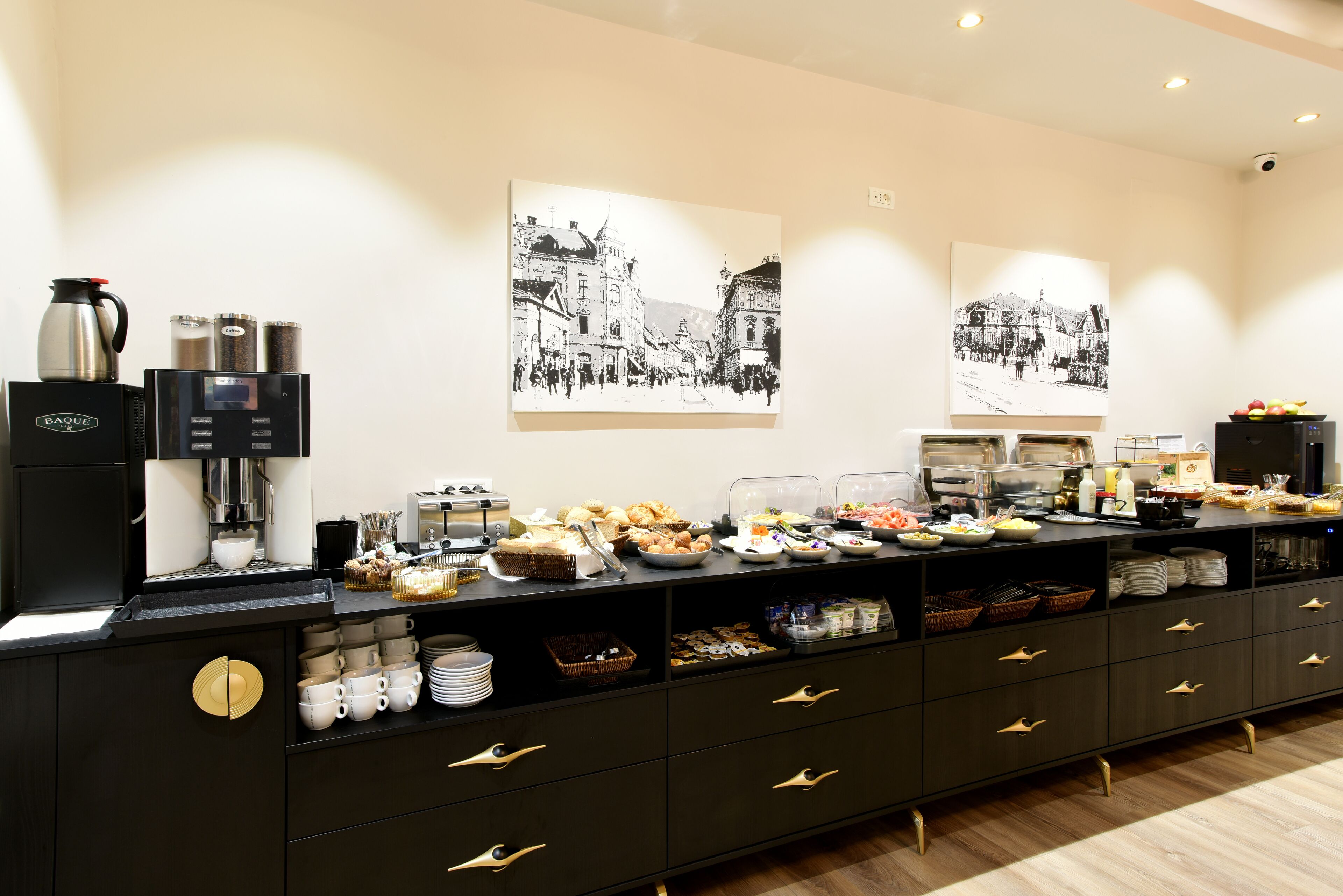 A buffet setup with various food items and a coffee station.