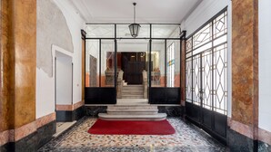 A grand entrance with a marble floor, a red carpet, and a staircase leading to an upper level. - Milan Retreats Brera (Milan)