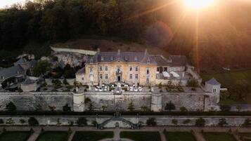 Perched on a hill, this grand château offers a scenic view of the surrounding landscape.