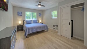 A bedroom with a bed, bedside tables, a ceiling fan, and two windows. - River Bend Bliss: Where Memories flow with the River (Cedar Creek)