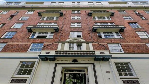 A multi-story building with a prominent entrance labeled "Hampton Court." - Heart Of The City Apartment In Heritage Building (Auckland)