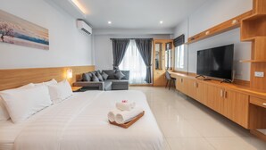 A modern hotel room with a large bed, a TV, a desk, and a sofa. - Gala Pavilion (Pattaya)