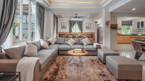 A modern living room with a grey sofa, a coffee table, and a shaggy rug. - Gala Pavilion (Pattaya)