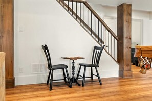 A staircase with wooden railings and a dark wooden column.