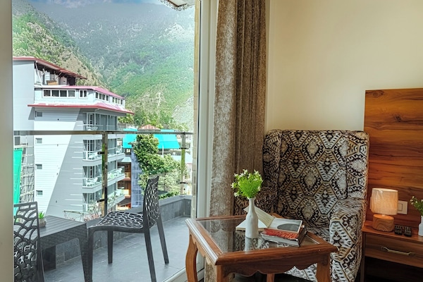 Super Deluxe Room with Balcony and Mountain view | Living area | 43-inch Smart TV with satellite channels