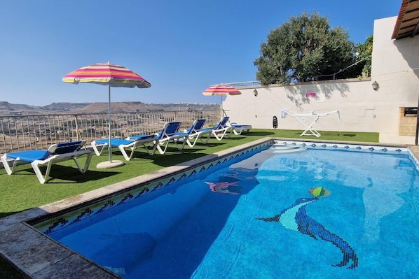 Relax by the pool surrounded by lush views and comfortable lounge seating.