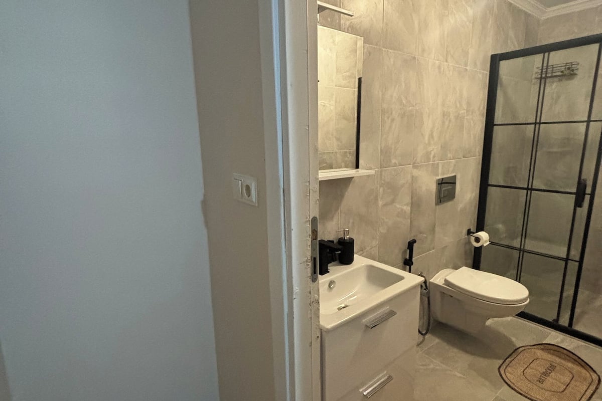 Shower, rainfall showerhead, hair dryer, towels