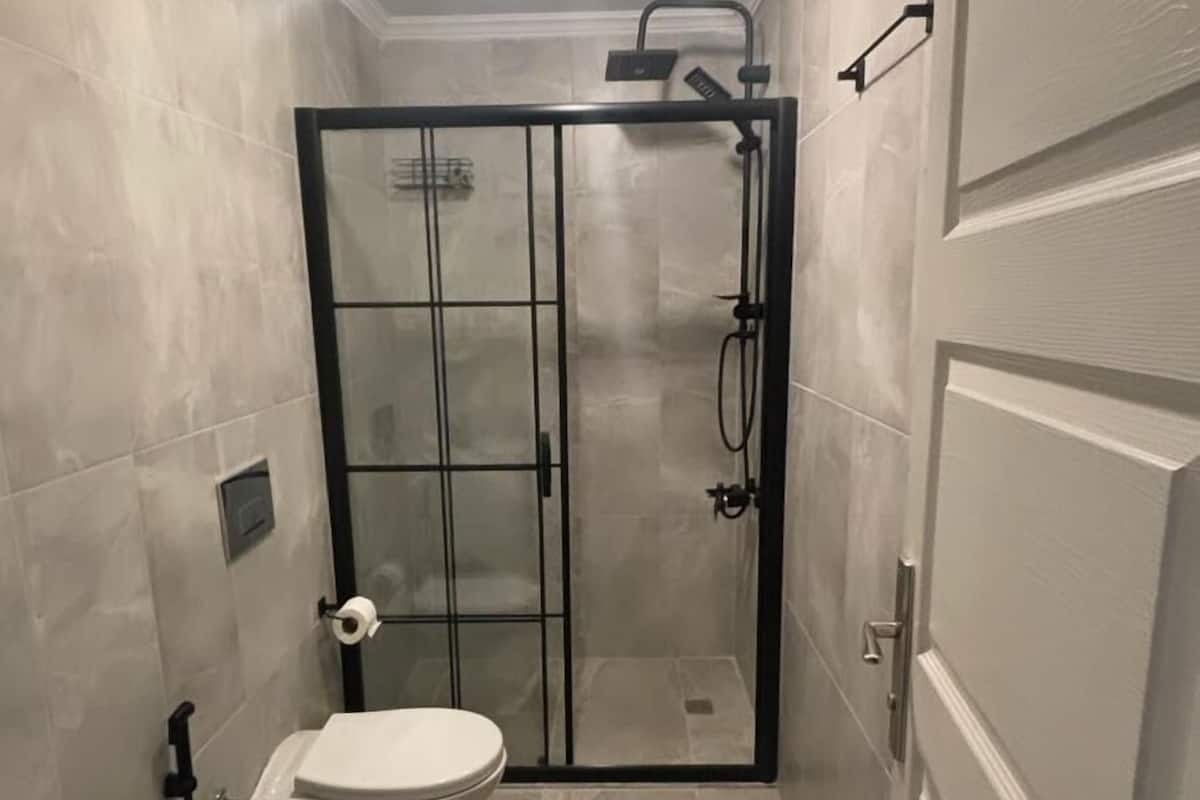 Shower, rainfall showerhead, hair dryer, towels