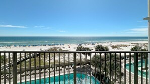 A balcony with a view of a beach, a pool, and a clear sky. - 3rd Floor!! Parking Level!  Avoid the Elevators!! (Orange Beach)