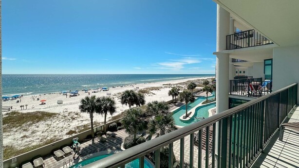 A balcony with a view of a beach and a swimming pool. - 3rd Floor!! Parking Level!  Avoid the Elevators!! (Orange Beach)