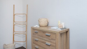 A wooden dresser with drawers and a woven basket on top. - Breezy, Stylish, Getaway (Tuncurry)