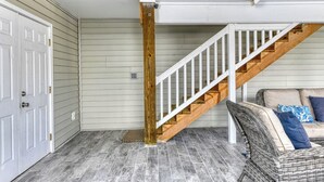 A staircase with wooden steps and white railings leading to an upper level. - Spacious 4 Bedroom, 3.5 Bath Garden City Beach Home with Private Pool (Garden City Beach)
