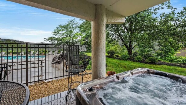 A hot tub, outdoor seating, and a pool. - GC106•walk downtown•onsite pool•private hot tub (Gatlinburg)
