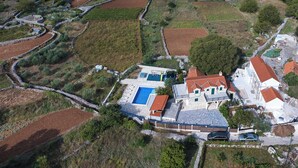 An aerial view of a property with a swimming pool, stone buildings, and terraced fields. - Villa Emanuel in Ljubitovica  - Haus für 4-6 Personen (Ljubitovica)