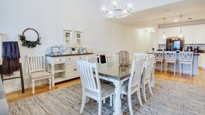 A spacious kitchen with white cabinetry, a central island, and a chandelier. - Walk to Boardwalk! Ocean City Coastal Gem w/ Deck (Ocean City)