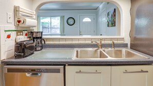 A kitchen with a double sink, a toaster, a coffee maker, and a dishwasher. - Pet-friendly Houston Vacation Rental w/ Patio! (Houston)