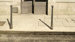 A building entrance with a metal door, a number plaque, and a small window above the door. - Milan Retreats Porta Romana (Milan)