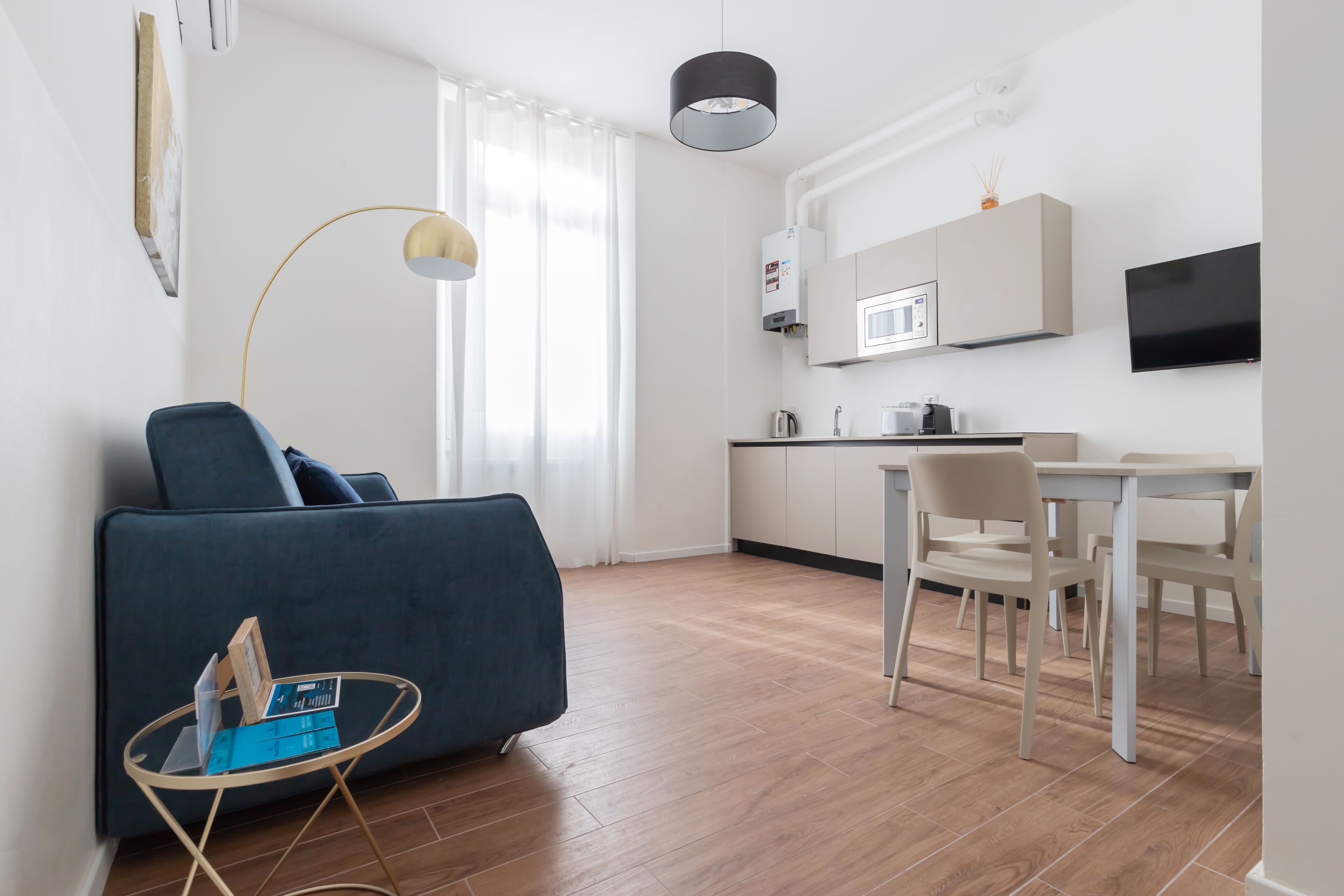 A modern apartment with a living room, kitchen, and dining area.