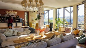 A modern living room with a sofa, a coffee table, and a chandelier.