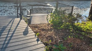 A wooden dock extending over a body of water with a bench and railing. - Beautiful Lakeside Condo/The Maples Golf Course On Site/Golf Haven/Near Pinehurst & Southern Pines/40 Golf courses minutes awaySleeps 9 (Vass)