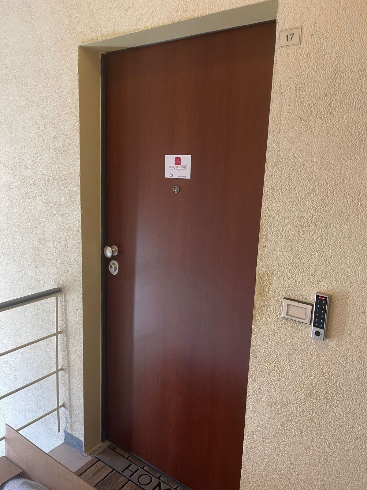 A brown door with a sign indicating it's a tourist house in Bologna, number 59.