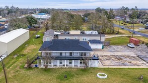 A residential property with a large house, a garage, and a fenced yard. - The Secret Bayou Retreat to Rest and Unwind - HAR1 (Iowa)