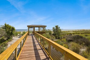 A wooden boardwalk leading to a covered pavilion with a view of the beach and ocean. - Pet Friendly Gated Home w/ Free Heated Pool, Half Mile to Fish Haul Beach (Hilton Head Island)