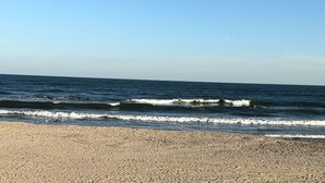 A beach with waves and a clear sky. - GulfScape2217 Seascape Condos 1bed1bath Beachfront Condo Ocean View from balcony (Galveston)
