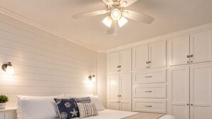 A bedroom with a bed, a ceiling fan, wall-mounted lights, and a wardrobe. - GulfScape2217 Seascape Condos 1bed1bath Beachfront Condo Ocean View from balcony (Galveston)