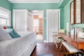 Cozy retreat with a large bed, desk, and comfortable seating area.