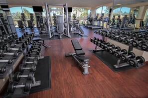 Stay fit and active with our well-equipped gym featuring a range of exercise equipment and large mirrors.