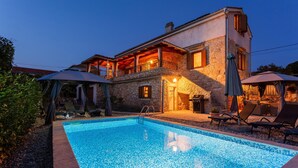 A two-story stone house with a swimming pool, outdoor seating, and a covered patio area. - Amazing home in Polje (Polje)