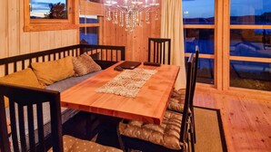 A cozy dining area with a wooden table, black chairs, and a bench. - Cozy home in Kjørsvikbugen with WiFi (Kjørsvikbugen)