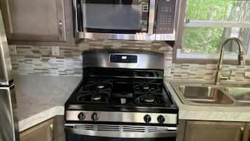 Cabin, Multiple Beds, Kitchen | Private kitchen | Fridge, microwave, stovetop, dishwasher