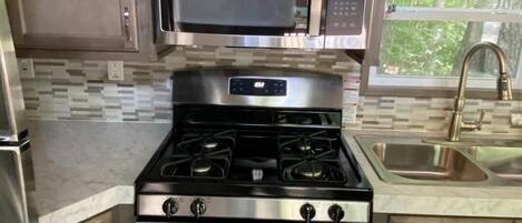 Cabin, Multiple Beds, Kitchen | Private kitchen | Fridge, microwave, stovetop, dishwasher