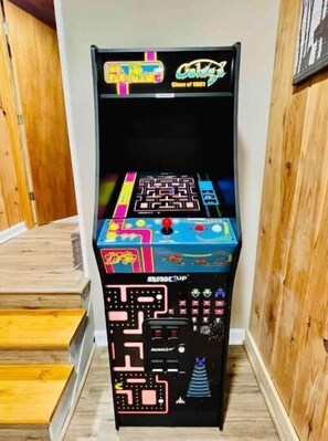 A retro arcade machine with colorful graphics and a maze game. - Cozy Mountain Cabin w/ Arcade Games, Pool Access, Hot Tub, and Fire Pit! (Ellijay)