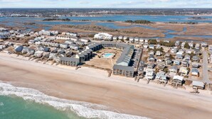 An aerial view of a coastal residential area with houses, a beach, and a river. - OceanScape- Beach and Sun in Surf City! (Surf City)