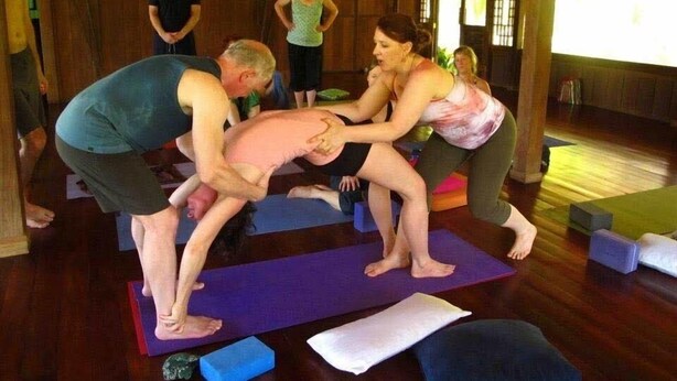 A yoga class in a wooden room with wooden floors and a sloped ceiling. - Ocean Forest Ecolodge Retreat (Drake Bay)