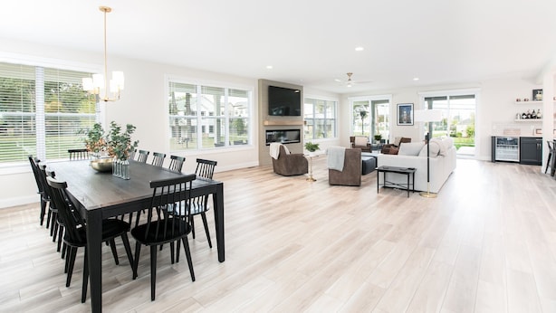 A spacious living area with a dining table, sofas, and a TV. - Victory Views Main House: Luxury Home for 20 Ppl (South Bend)