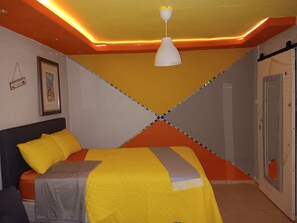 A room with a bed, a hanging light fixture, and a door. - Villamar 3 (Vega Baja)
