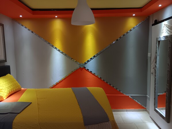A modern bedroom with a bed, a hanging light fixture, and a glass door. - Villamar 3 (Vega Baja)