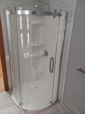Shower, hair dryer, towels, toilet paper