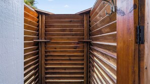 A wooden staircase leading to a door with a metal handle.