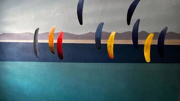 A mural with abstract shapes and a landscape background.