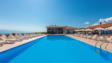 Seasonal outdoor pool, open 9:00 AM to 9:00 PM, pool umbrellas