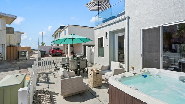 A backyard with outdoor furniture, a hot tub, and a barbecue area. - Mission Paradise - Spa, Pet Friendly, Steps to Sand & W/D! (Mission Beach)